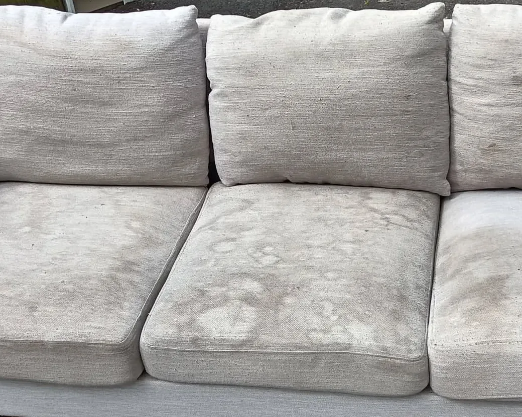 Light gray three seater sofa before cleaning